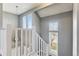 Bright staircase with white railings and gray walls at 11615 Masonville Dr, Parker, CO 80134