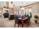 Bright dining room features a wood table with black leather chairs, and a view into the living room at 10515 Ashfield St # 1D, Highlands Ranch, CO 80126