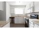 Compact kitchen featuring white cabinetry, black appliances, and speckled countertops at 14330 E Mississippi Ave # E, Aurora, CO 80012