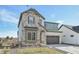 Two-story home with stone and siding exterior, two-car garage, and landscaped yard at 5960 S Platte Canyon Dr, Littleton, CO 80123