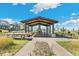 Outdoor community pavilion with fireplace and seating at 21202 E 63Rd Dr, Aurora, CO 80019