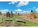 playground with play structures and benches at 21202 E 63Rd Dr, Aurora, CO 80019