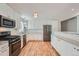 Modern kitchen with white cabinets, granite counters, and stainless steel appliances at 13194 W 23Rd Ave, Golden, CO 80401