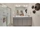 Elegant bathroom with dual sinks, large mirror, and contemporary finishes at 4562 Cattle Cross Trl, Castle Rock, CO 80104