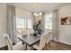 Bright and airy dining room with a large table, stylish curtains, and access to the outdoors at 4562 Cattle Cross Trl, Castle Rock, CO 80104