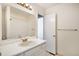 Clean bathroom with white tile, a vanity sink, and a bathtub at 1915 S Balsam St, Lakewood, CO 80227