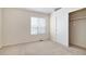 Another view of a bedroom with carpeted flooring, a window with blinds, and a closet at 1915 S Balsam St, Lakewood, CO 80227