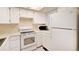 Bright kitchen features white appliances, ample counter space, and plenty of cabinets at 1915 S Balsam St, Lakewood, CO 80227