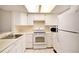 Bright kitchen featuring white appliances and ample cabinetry at 1915 S Balsam St, Lakewood, CO 80227