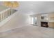 Living room with a fireplace, carpet flooring, and stairs at 1915 S Balsam St, Lakewood, CO 80227