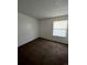Bright bedroom featuring a large window and brown carpeting at 2125 S Telluride Ct, Aurora, CO 80013