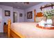 Main bedroom with wood bed frame, tan bedding, and decorative accents at 12222 Bannock Cir # D, Denver, CO 80234