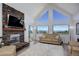 Spacious living room with stone fireplace, vaulted ceiling, and scenic views at 11251 Forest Hills Dr, Parker, CO 80138
