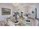 Elegant dining room with glass table and kitchen access at 11251 Forest Hills Dr, Parker, CO 80138