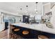 Modern kitchen with a large island, white and blue cabinets, and stainless steel appliances at 1710 Sunlight Dr, Longmont, CO 80504