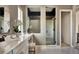 Spa-like bathroom with double vanity, large shower, and elegant fixtures at 16975 Black Rose Cir, Parker, CO 80134