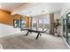 Finished basement recreation room with ping pong table, sitting area, and plenty of natural light at 16975 Black Rose Cir, Parker, CO 80134