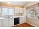 White kitchen cabinets, hardwood floors and a built in microwave at 8732 Snowbird Way, Parker, CO 80134