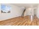 Living room with hardwood floors and view to entryway at 5411 Elm Ct, Denver, CO 80221