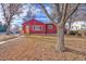 Charming ranch home with red siding and a well-maintained lawn at 1791 S Filbert Ct, Denver, CO 80222