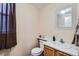 Clean bathroom with single sink vanity and decorative mirror at 10461 Tucson St, Commerce City, CO 80022