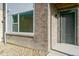 Front entrance of townhome with brick facade and gray door at 461 Interlocken Blvd # 101, Broomfield, CO 80021