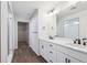 Bathroom with double vanity, walk-in shower, and large mirror at 7375 S Waterloo Way, Aurora, CO 80016