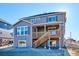 Two-story home with gray siding, deck, and stairs leading to backyard at 7375 S Waterloo Way, Aurora, CO 80016