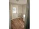 Laundry room with white door and wood-look flooring at 1749 Macon St, Aurora, CO 80010