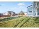 Large backyard with grassy area, partially covered in snow at 12956 E 107Th Pl, Commerce City, CO 80022