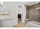 Bathroom with shower, vanity, and a view into another room at 12956 E 107Th Pl, Commerce City, CO 80022