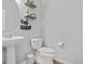 Clean bathroom with pedestal sink and toilet at 12956 E 107Th Pl, Commerce City, CO 80022