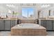 Main bathroom with soaking tub, double vanities, and large window at 12956 E 107Th Pl, Commerce City, CO 80022