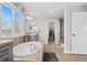 Spa-like bathroom with soaking tub, double sinks, and walk-in shower at 12956 E 107Th Pl, Commerce City, CO 80022