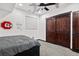 Basement bedroom with double doors and ceiling fan at 12956 E 107Th Pl, Commerce City, CO 80022
