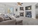 Gathering room with a fireplace, built-in shelving, and large sectional sofa at 12956 E 107Th Pl, Commerce City, CO 80022