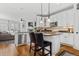 Open kitchen features granite countertops, stainless steel appliances, and island seating at 12956 E 107Th Pl, Commerce City, CO 80022