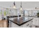 Modern kitchen with granite island and white cabinets at 12956 E 107Th Pl, Commerce City, CO 80022