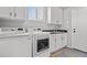 Convenient laundry room with washer, dryer, and cabinets at 12956 E 107Th Pl, Commerce City, CO 80022