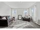 Cozy living room with two sofas and a large window at 12956 E 107Th Pl, Commerce City, CO 80022