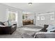 Spacious living room with plush sofas and ample natural light at 12956 E 107Th Pl, Commerce City, CO 80022