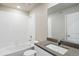 Clean bathroom with white tiled walls and a modern vanity at 3036 Oxley St, Strasburg, CO 80136