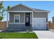 Charming house with gray siding, a white door, and a well-manicured lawn at 2420 Christina St, Fort Lupton, CO 80621