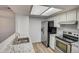 Modern kitchen with stainless steel appliances and granite countertops at 7870 W 87Th Dr # J, Arvada, CO 80005
