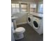 Bathroom with toilet, sink, and laundry appliances at 841 N Bross St, Longmont, CO 80501