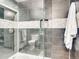 Walk-in shower with pebble tile and glass enclosure at 2441 N Broadway # 113, Denver, CO 80205