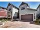 Two-story home with a gray exterior and brown garage door at 9657 Bennett Peak St, Littleton, CO 80125