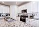 Modern kitchen featuring white cabinets and granite countertops at 9657 Bennett Peak St, Littleton, CO 80125