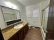 Bathroom with shower/tub combo and wood vanity at 2084 S Rifle St, Aurora, CO 80013