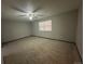 Spacious carpeted bedroom with a window and ceiling fan at 2084 S Rifle St, Aurora, CO 80013